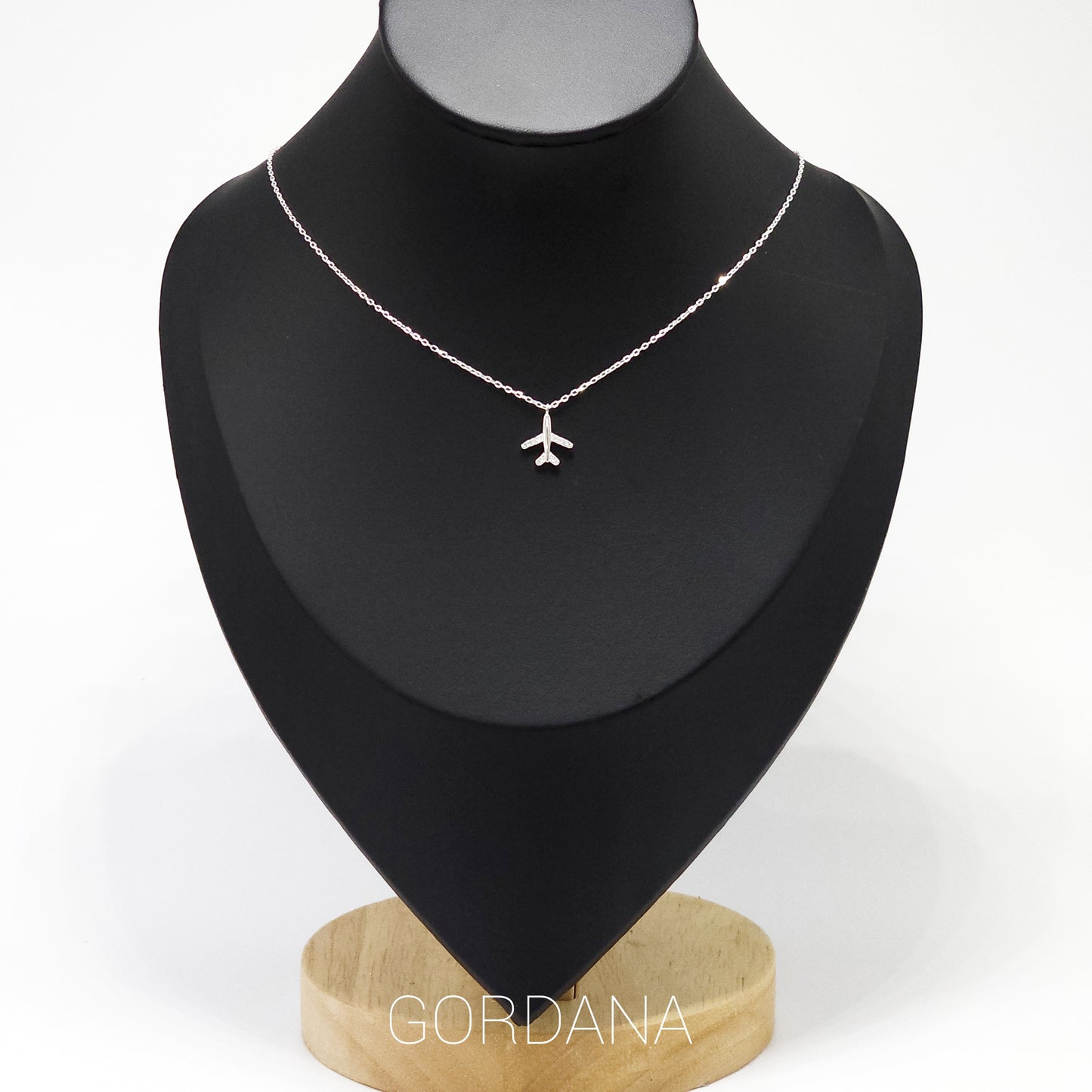 Silver airplane pendant necklace in stainless steel, elegant unisex fashion jewelry for Mauritius, Europe, and USA style.