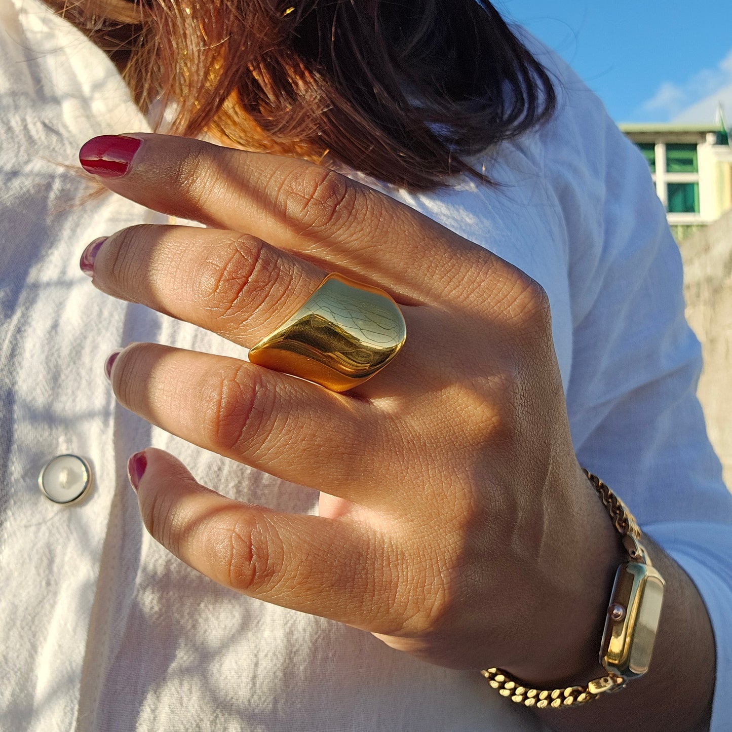 Bold 18K gold plated stainless steel ring on hand, elegant silver jewelry, unisex fashion piece with Mauritius Europe USA.