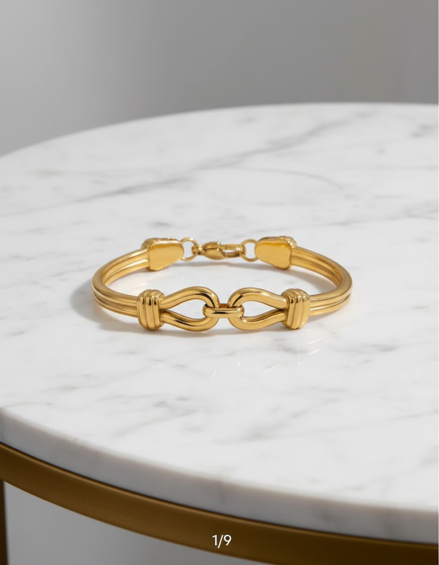 Gold bracelet on a marble surface