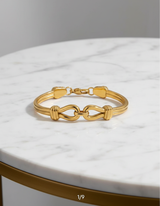 Gold bracelet on a marble surface