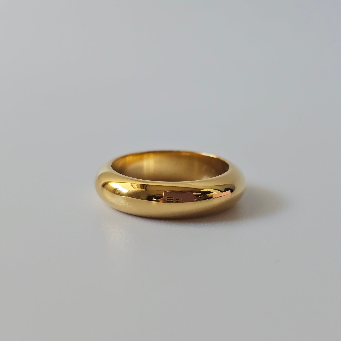 Elegant 18K gold plated stainless steel ring with smooth, polished finish, unisex jewelry style.